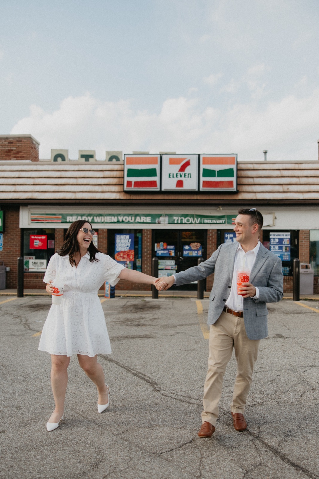 Laughing hand in hand outside 7-Eleven, Slurpees in tow
